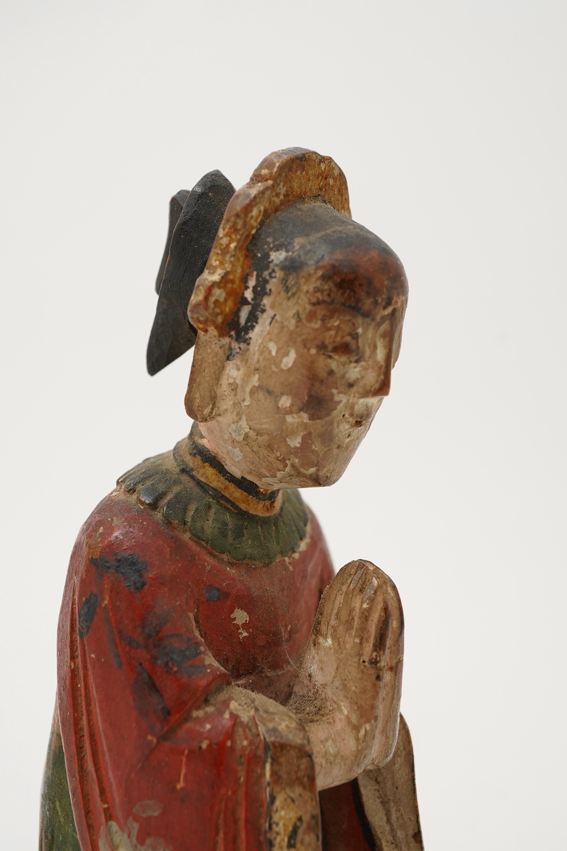 A Chinese polychrome wood figure of a female attendant, Qing dynasty
